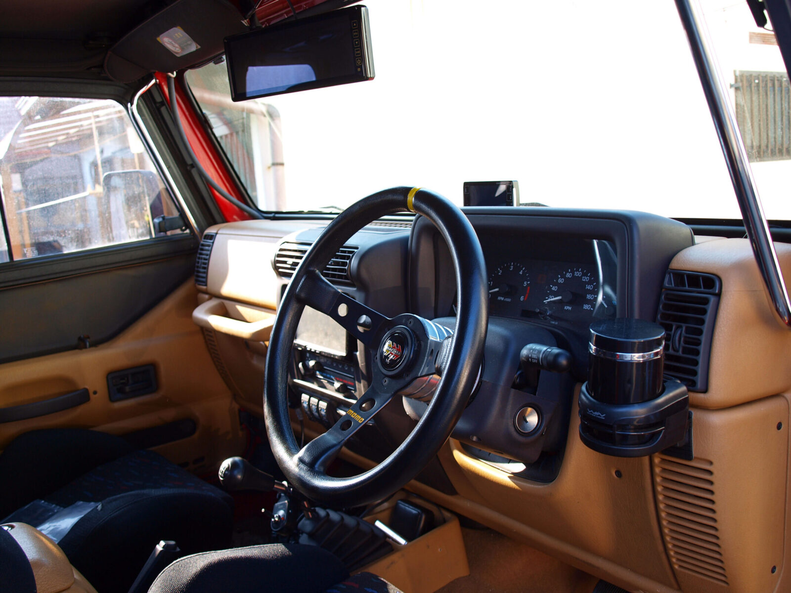 TJ WRANGLER SAITO AUTO SERVICE タン色のインテリアにMOMOの黒革ステアリングが映える。